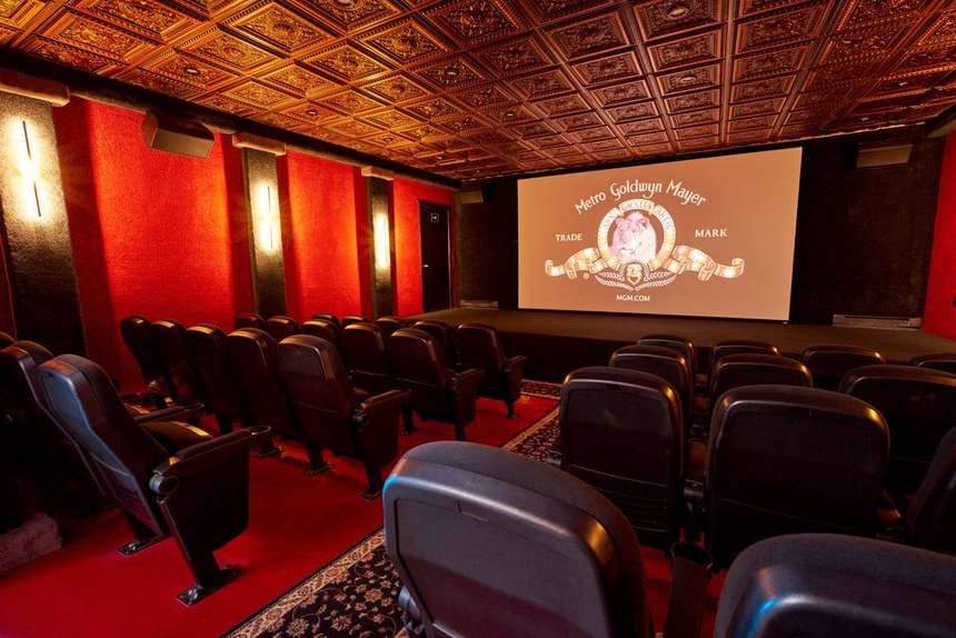 The Mansion theater, red walls and a gold coffered ceiling above rows of cinema seats
