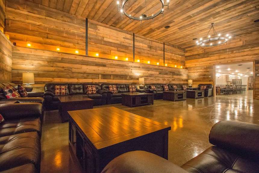 The Castle living room, timber-lined with seating for the whole group